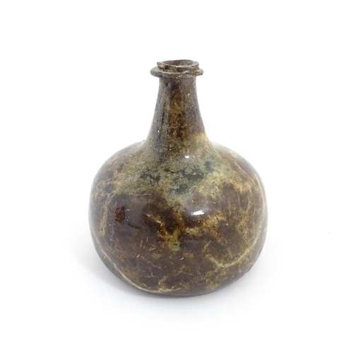 226 - A late 18thC / early 19thC English dark olive green glass onion shape wine bottle. Approx. 6