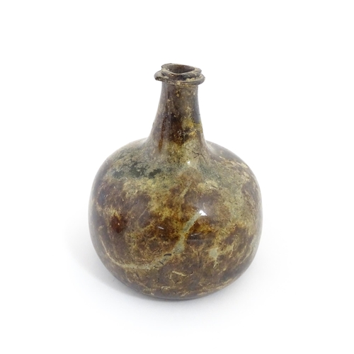 226 - A late 18thC / early 19thC English dark olive green glass onion shape wine bottle. Approx. 6