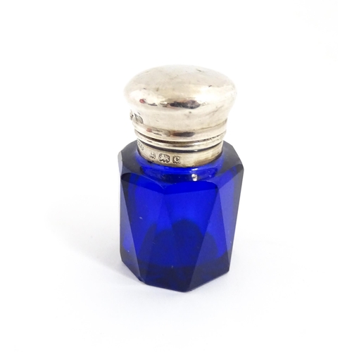 227 - A blue glass scent / salts bottle with silver top hallmarked Birmingham 1902, maker Cornelius Desorm... 