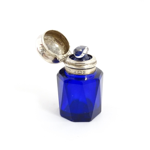 227 - A blue glass scent / salts bottle with silver top hallmarked Birmingham 1902, maker Cornelius Desorm... 