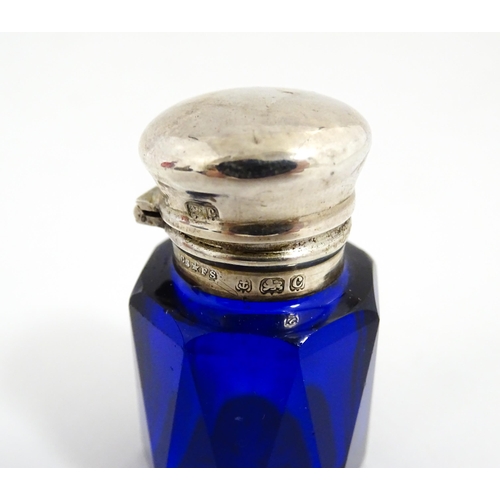 227 - A blue glass scent / salts bottle with silver top hallmarked Birmingham 1902, maker Cornelius Desorm... 