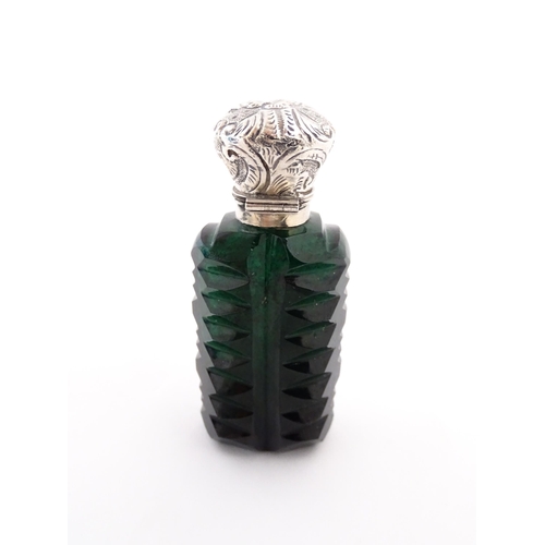 236 - A green cut glass scent / perfume bottle with stopper. Approx. 3