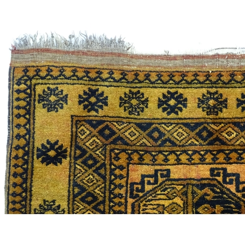 1379 - Carpet / Rug: An ochre ground rug decorated with centre vignettes with geometric motifs, further rep... 