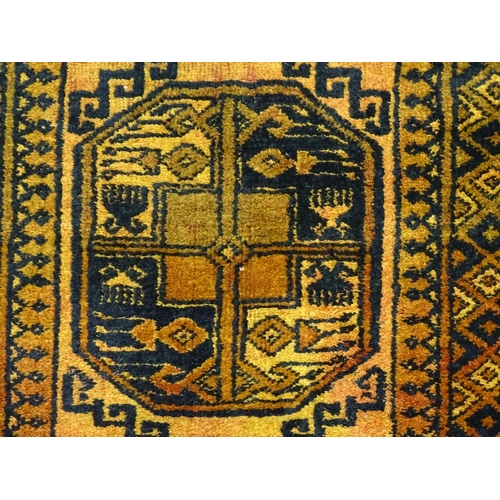 1379 - Carpet / Rug: An ochre ground rug decorated with centre vignettes with geometric motifs, further rep... 