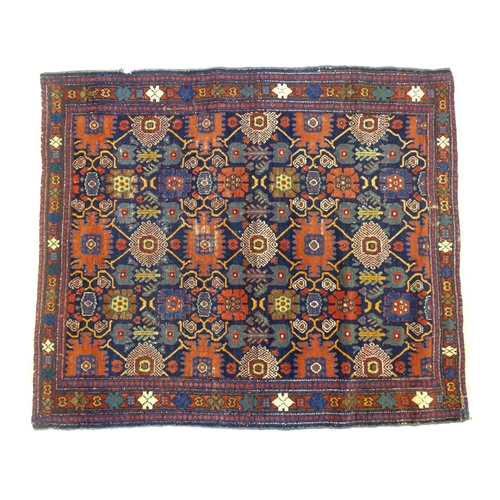 1382 - Carpet / Rug: A blue ground rug decorated with repeating geometric motifs of stylised floral and fol... 