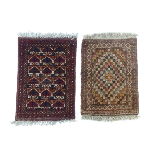 1384 - Carpets / Rugs: Two small rugs, one with burgundy ground with repeating motifs, the other with salmo... 