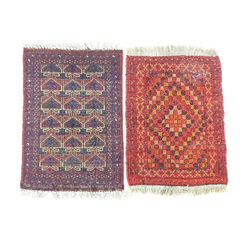 1384 - Carpets / Rugs: Two small rugs, one with burgundy ground with repeating motifs, the other with salmo... 