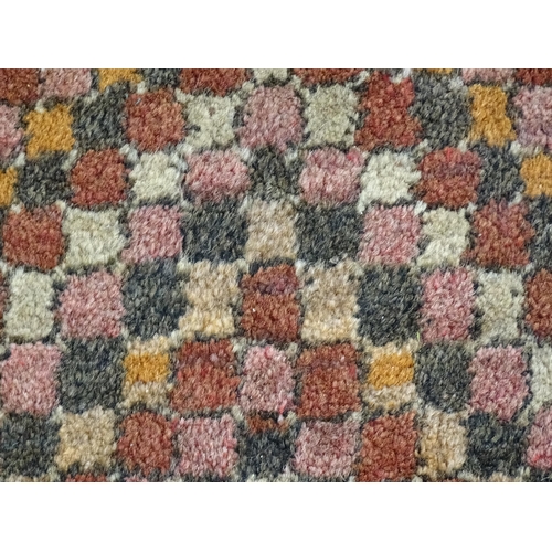 1384 - Carpets / Rugs: Two small rugs, one with burgundy ground with repeating motifs, the other with salmo... 