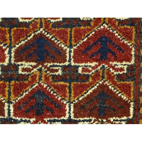 1384 - Carpets / Rugs: Two small rugs, one with burgundy ground with repeating motifs, the other with salmo... 