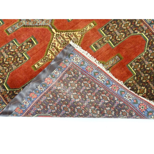 1385 - Carpet / Rug : A North West Persian Senneh runner with a red ground decorated with central repeating... 