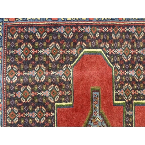 1385 - Carpet / Rug : A North West Persian Senneh runner with a red ground decorated with central repeating... 