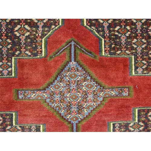 1385 - Carpet / Rug : A North West Persian Senneh runner with a red ground decorated with central repeating... 