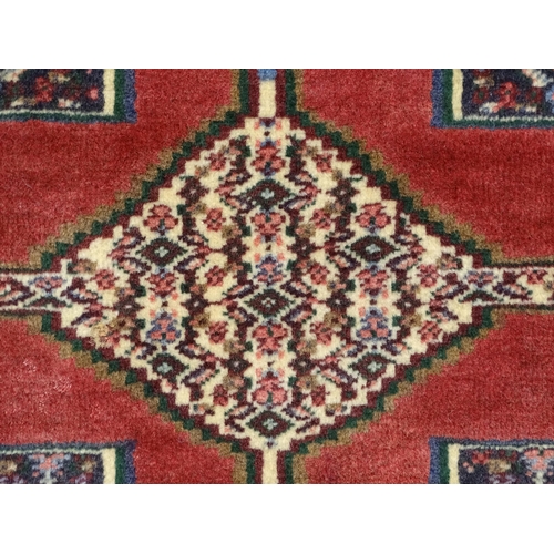 1385 - Carpet / Rug : A North West Persian Senneh runner with a red ground decorated with central repeating... 