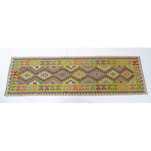 1386 - Carpet / Rug : A Turkish Anatolian kilim rug / runner with repeating geometric motifs. Approx. 34