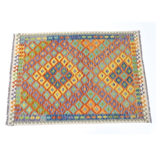 1388 - Carpet / Rug : A Turkish Anatolian kilim rug with repeated geometric motifs. Approx. 84