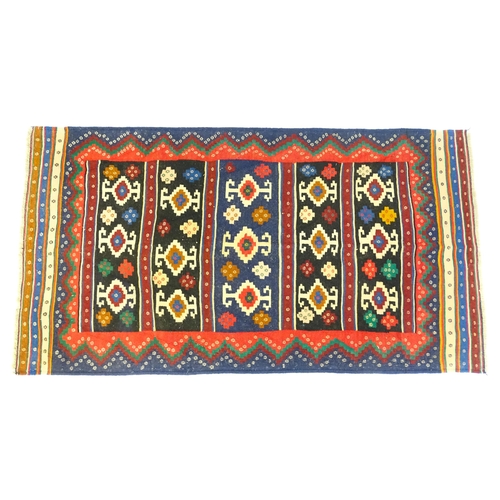 1392 - Carpet / Rug : A North East Persian Sumak kilim rug with banded geometric decoration. Approx. 79