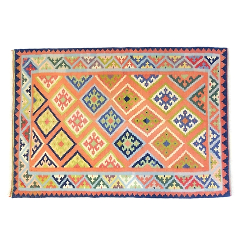 1394 - Carpet / Rug : A South West Persian qashgai kilim rug, the salmon ground with repeating geometric mo... 