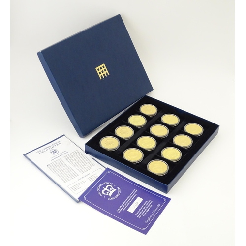 896 - Coins: A boxed set of twelve Westminster Mint gold plated medallions titled the Crown Jewels Coin Co... 