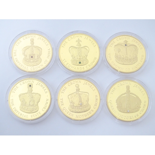 896 - Coins: A boxed set of twelve Westminster Mint gold plated medallions titled the Crown Jewels Coin Co... 