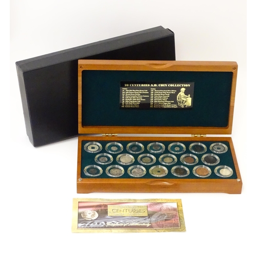 897 - Coins: A cased collection of coins titled The Twenty Centuries AD - Coin Collection, produced by the... 