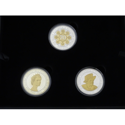 907 - Coins: a 2022 Royal Mint Queen Elizabeth II platinum jubilee commemorative £5 set, comprising three ... 