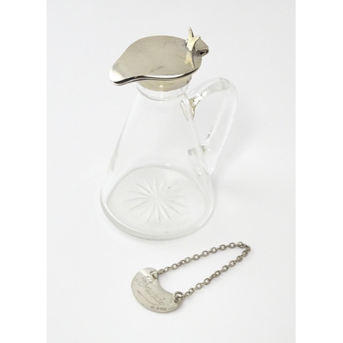 245 - A glass whisky water noggin / jug with silver lid, hallmarked Birmingham 1931. Together with matchin... 