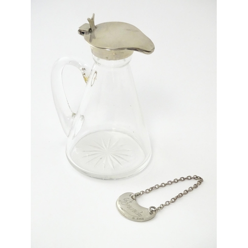 245 - A glass whisky water noggin / jug with silver lid, hallmarked Birmingham 1931. Together with matchin... 