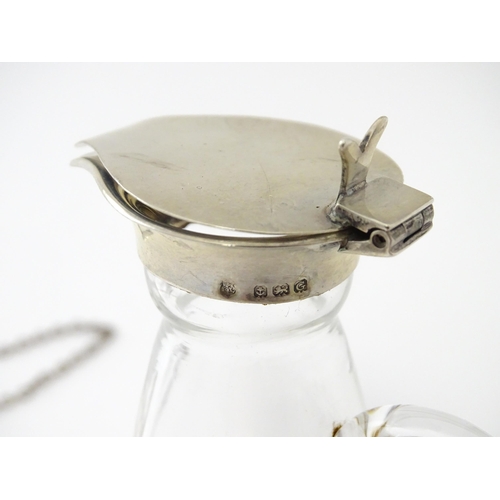 245 - A glass whisky water noggin / jug with silver lid, hallmarked Birmingham 1931. Together with matchin... 