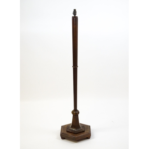 1420 - An Art Deco style oak standard lamp with a chamfered stem and a moulded hexagonal base. Approx. 56