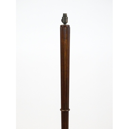 1420 - An Art Deco style oak standard lamp with a chamfered stem and a moulded hexagonal base. Approx. 56