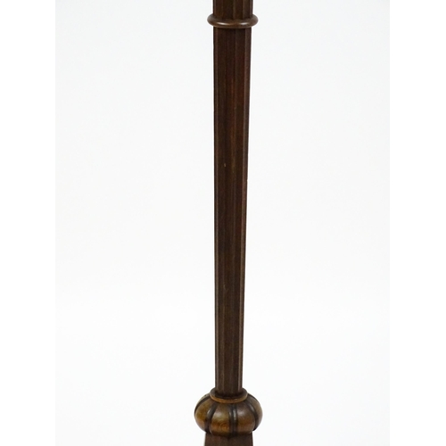 1420 - An Art Deco style oak standard lamp with a chamfered stem and a moulded hexagonal base. Approx. 56