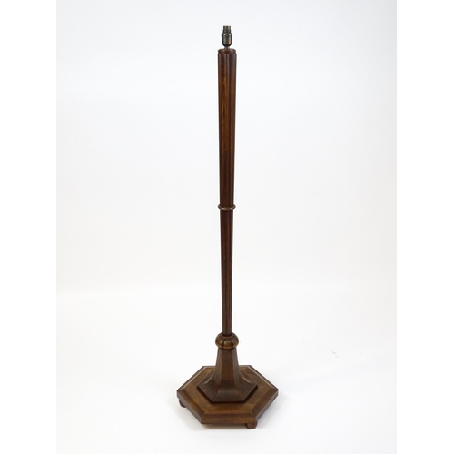 1420 - An Art Deco style oak standard lamp with a chamfered stem and a moulded hexagonal base. Approx. 56