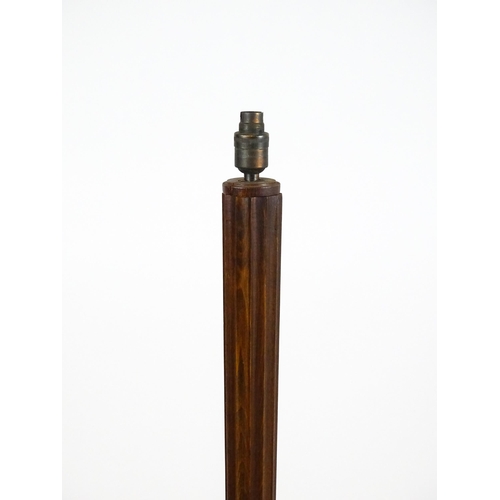 1420 - An Art Deco style oak standard lamp with a chamfered stem and a moulded hexagonal base. Approx. 56