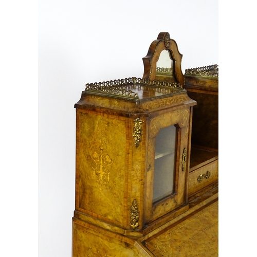 1476 - A 19thC burr walnut Bonheur du jour with a mirrored back stand and flanked by two glazed cabinets wi... 