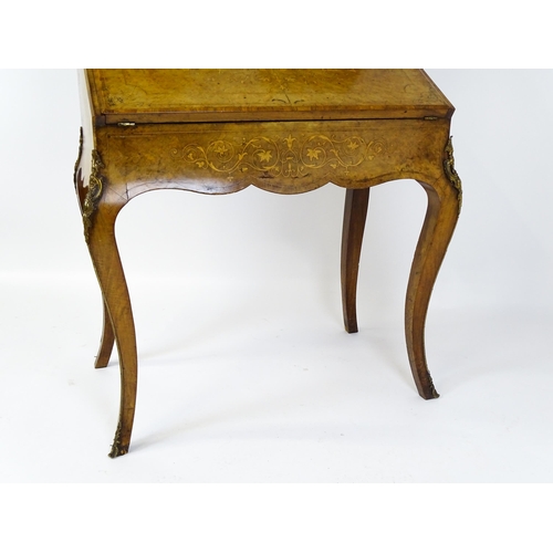 1476 - A 19thC burr walnut Bonheur du jour with a mirrored back stand and flanked by two glazed cabinets wi... 