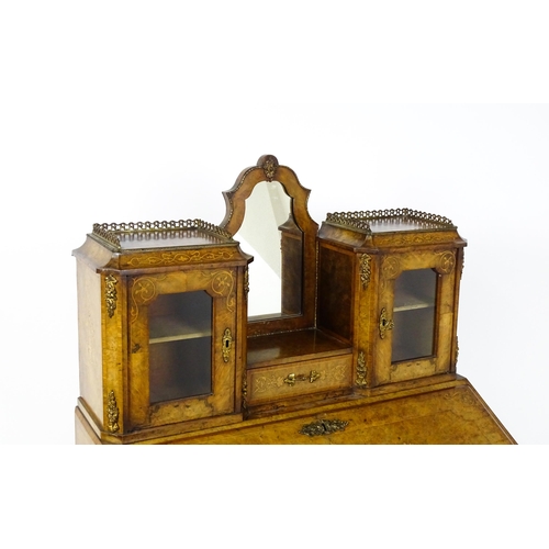 1476 - A 19thC burr walnut Bonheur du jour with a mirrored back stand and flanked by two glazed cabinets wi... 