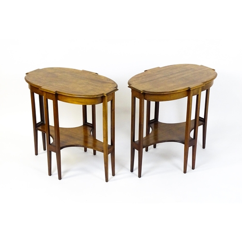 1480 - A pair of late 19thC / early 20thC mahogany side tables, each with shaped tops and having eight tape... 