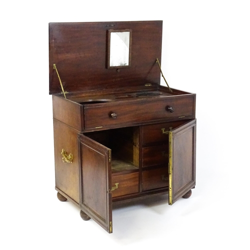 1486 - A Georgian mahogany campaign washstand with a mirror to the interior and sections for internal fitti... 