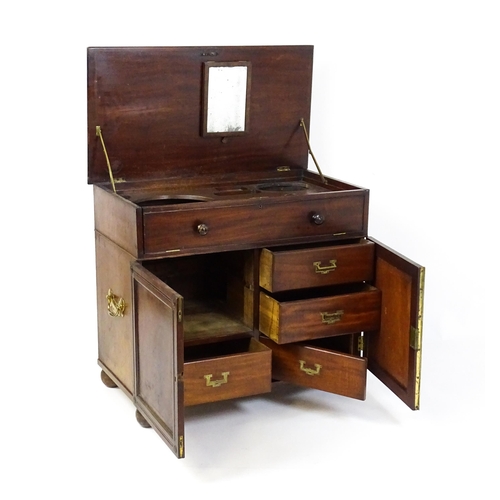 1486 - A Georgian mahogany campaign washstand with a mirror to the interior and sections for internal fitti... 