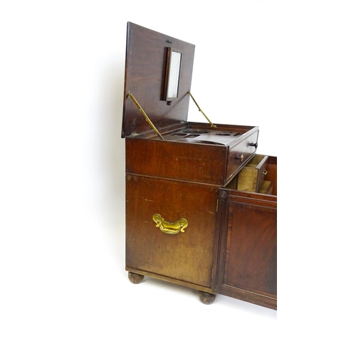 1486 - A Georgian mahogany campaign washstand with a mirror to the interior and sections for internal fitti... 