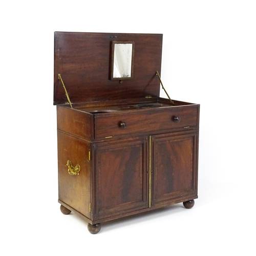 1486 - A Georgian mahogany campaign washstand with a mirror to the interior and sections for internal fitti... 