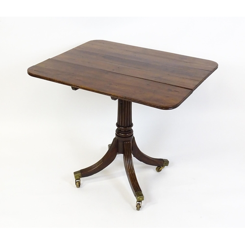 1488 - A 19thC tilt top occasional table with yew wood planked top above a reeded mahogany pedestal and fou... 