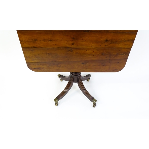 1488 - A 19thC tilt top occasional table with yew wood planked top above a reeded mahogany pedestal and fou... 