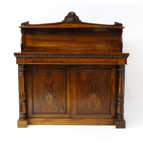 1489 - A 19thC rosewood chiffonier with a shaped upstand surmounted by a carved crest and a long shelf supp... 