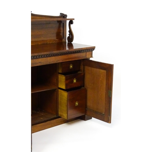 1489 - A 19thC rosewood chiffonier with a shaped upstand surmounted by a carved crest and a long shelf supp... 