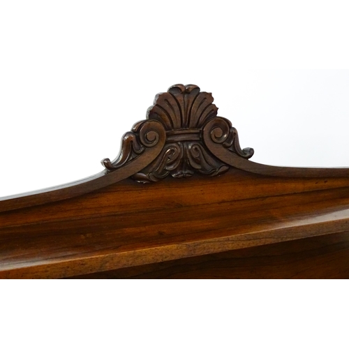 1489 - A 19thC rosewood chiffonier with a shaped upstand surmounted by a carved crest and a long shelf supp... 