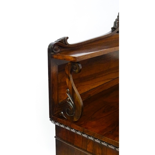 1489 - A 19thC rosewood chiffonier with a shaped upstand surmounted by a carved crest and a long shelf supp... 