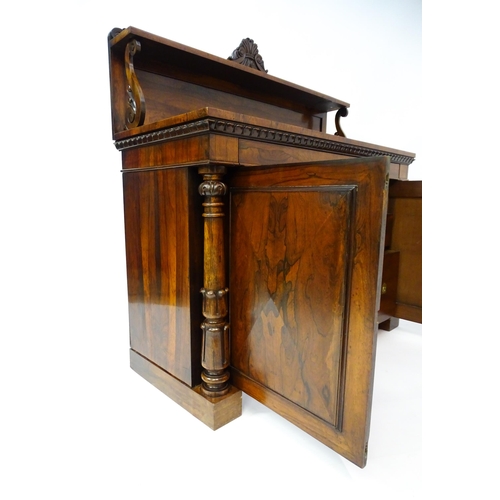 1489 - A 19thC rosewood chiffonier with a shaped upstand surmounted by a carved crest and a long shelf supp... 