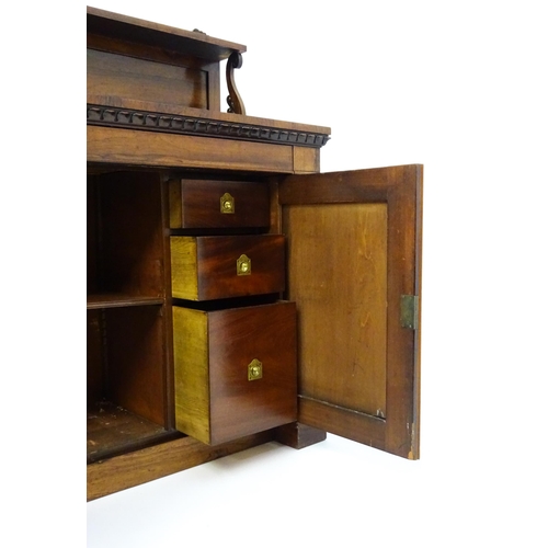 1489 - A 19thC rosewood chiffonier with a shaped upstand surmounted by a carved crest and a long shelf supp... 