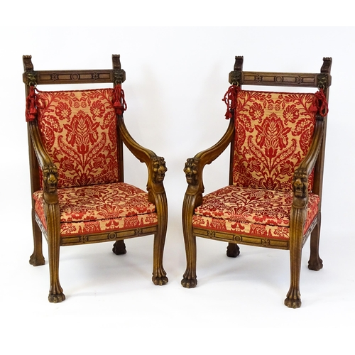 1497 - A pair of 19thC continental mahogany armchairs surmounted by corbel style reeded mounts and lions ma... 